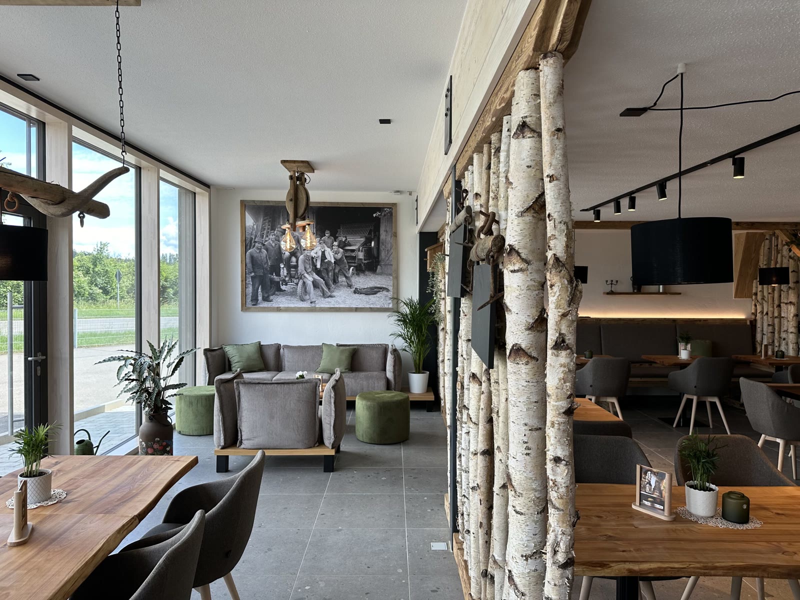 Innenraum des Hofcafés mit Birkenstämmen und Sitzecke